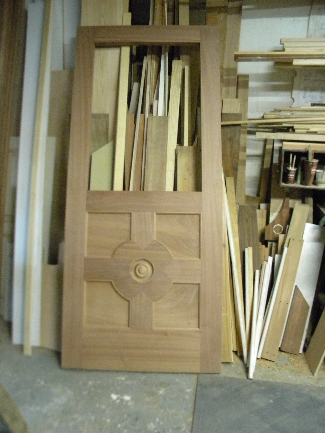 a wooden reproduction door is sitting in a pile of wood