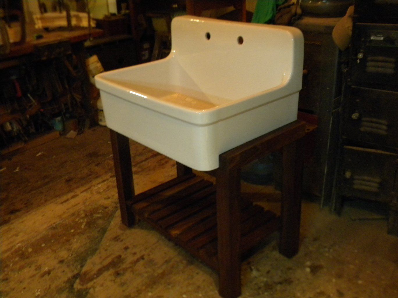 a custom built white window with a roof is sitting on a table in a workshop