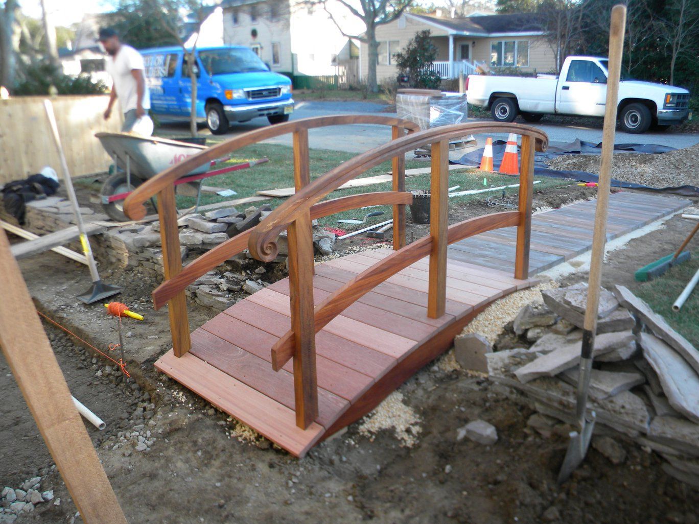 a small wooden bridge is being built in the dirt