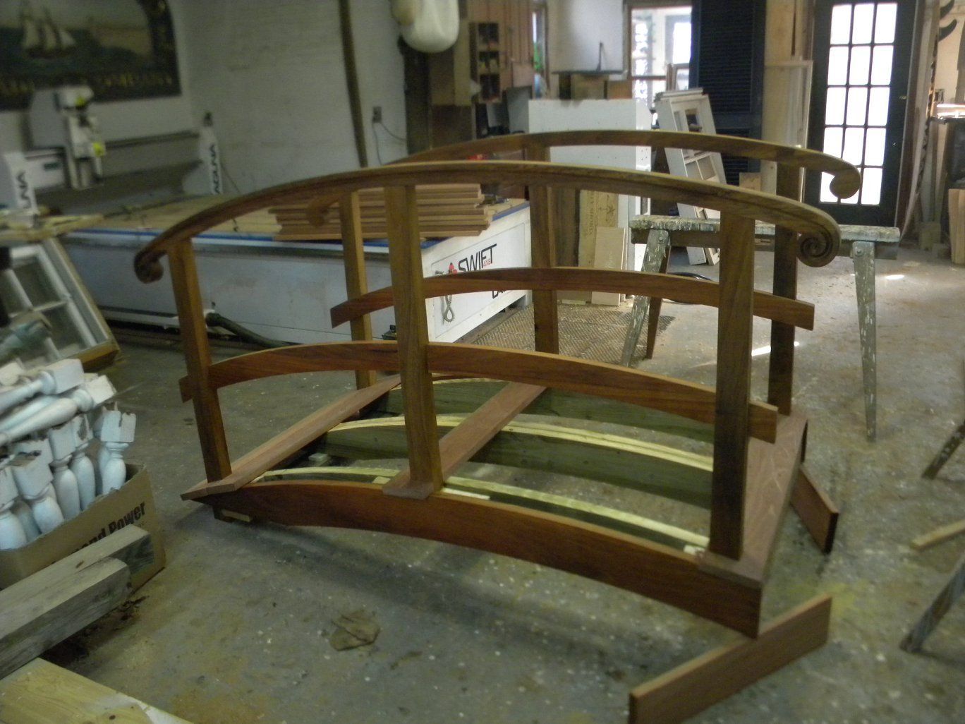 A wooden bridge is being built in a workshop