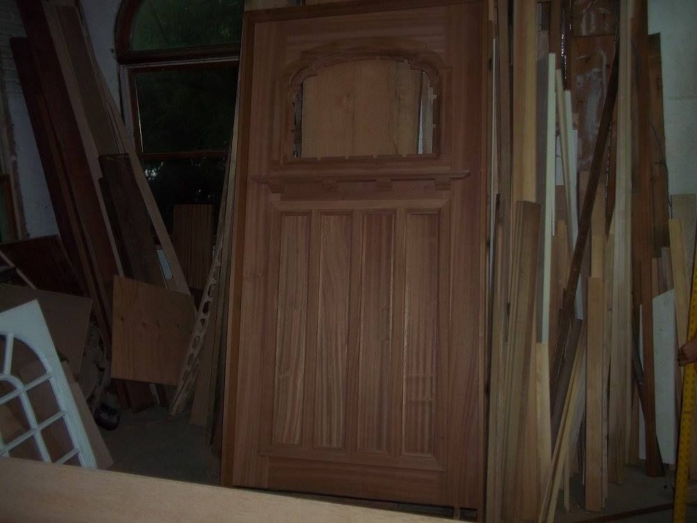 a wooden door is sitting on top of a pile of wood
