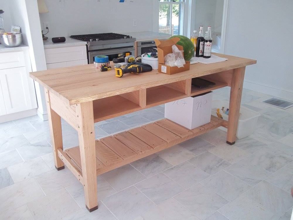 a custom built wooden table in a kitchen with a box on it