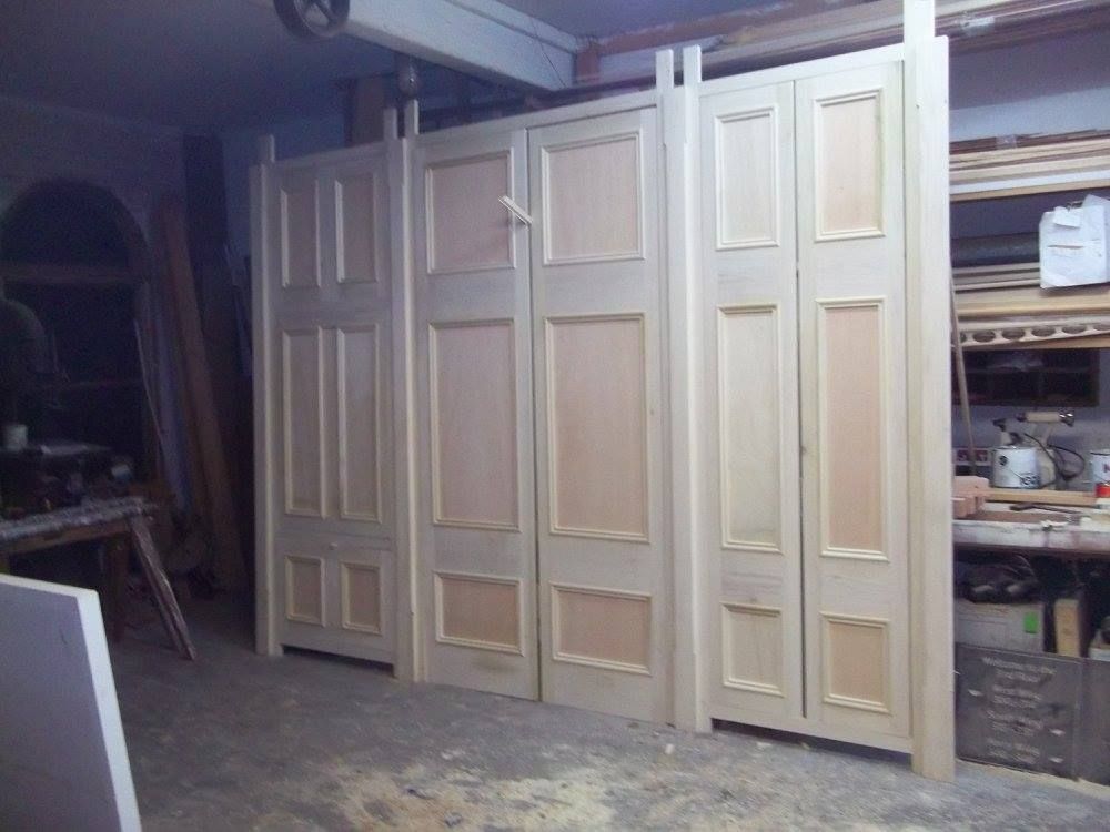 a row of custom wooden doors are lined up in a room