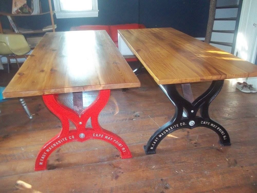 a custom wooden table with a red base and a black base