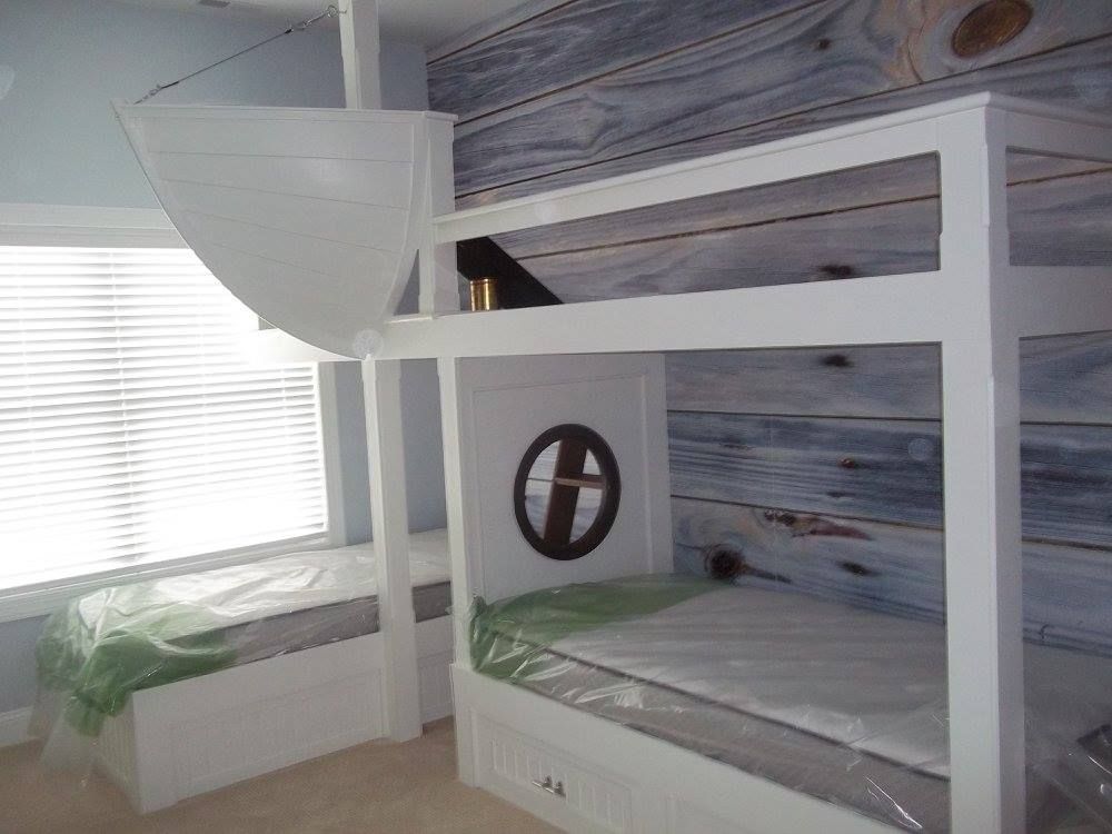 a bedroom with a custom built bunk bed and a window