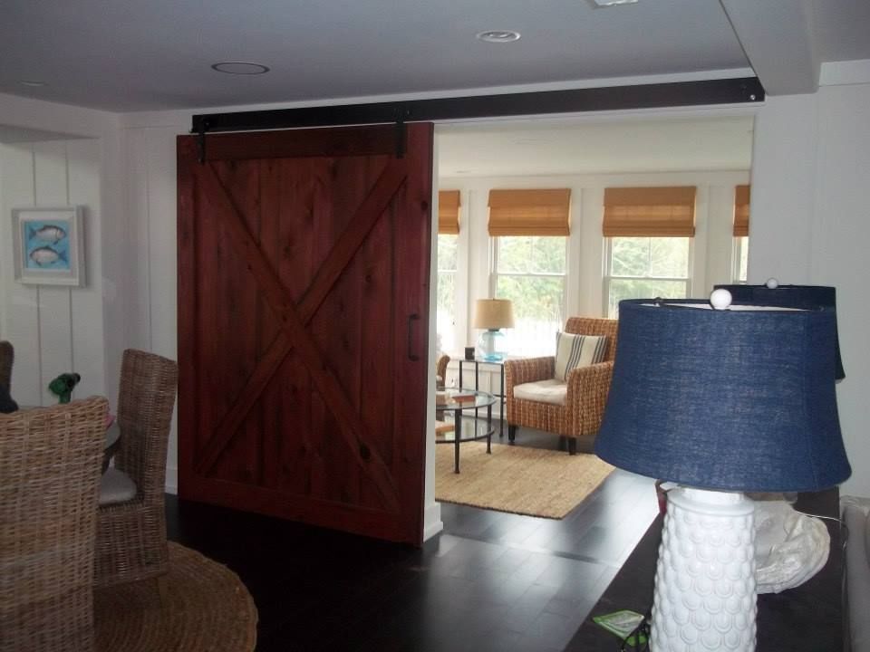 a living room with a custom built sliding barn door