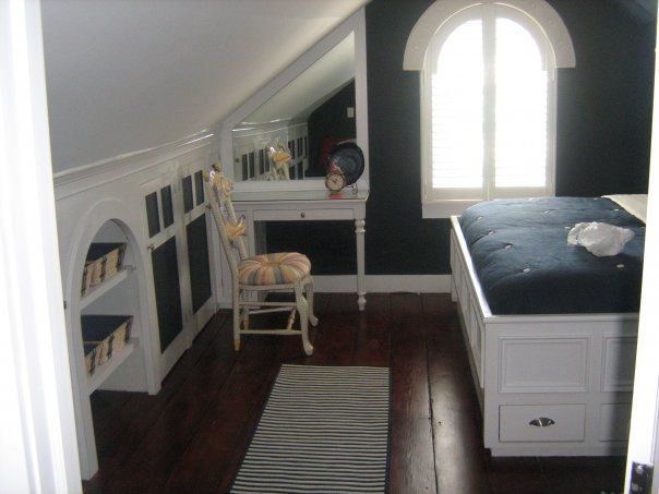a room with a custom built bed and a chair in it
