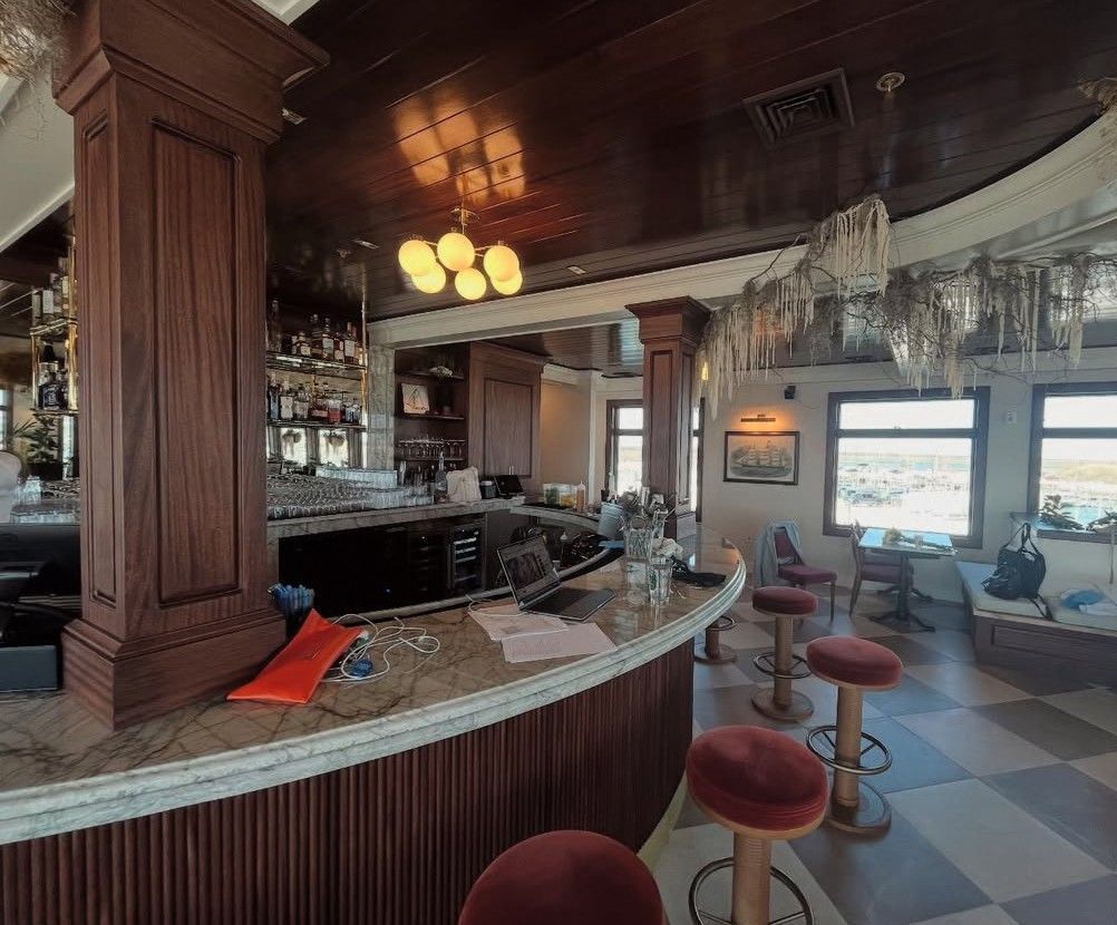 A restaurant with a bar and stools in it