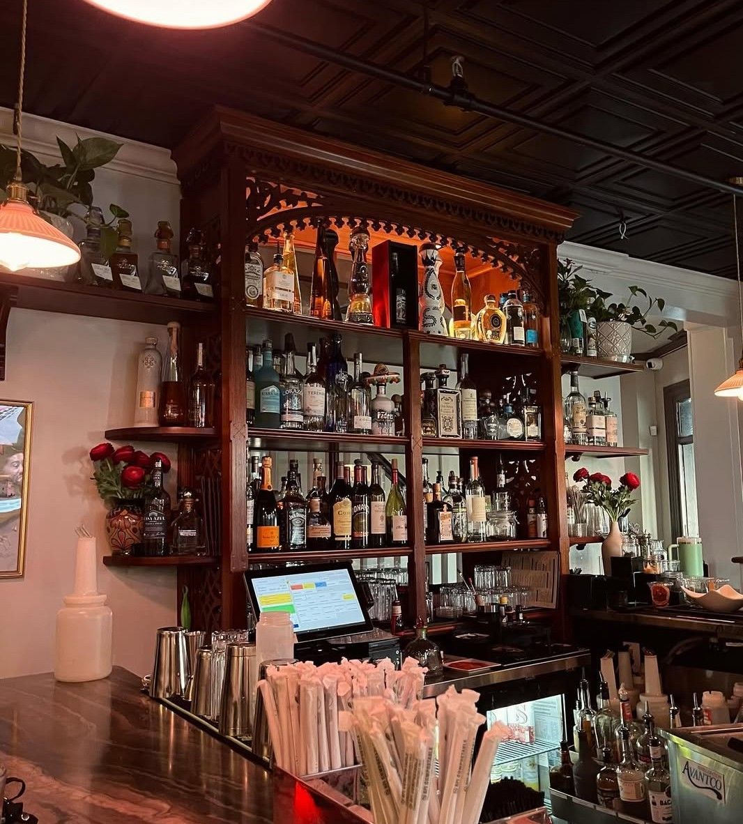 A bar with a lot of bottles on shelves