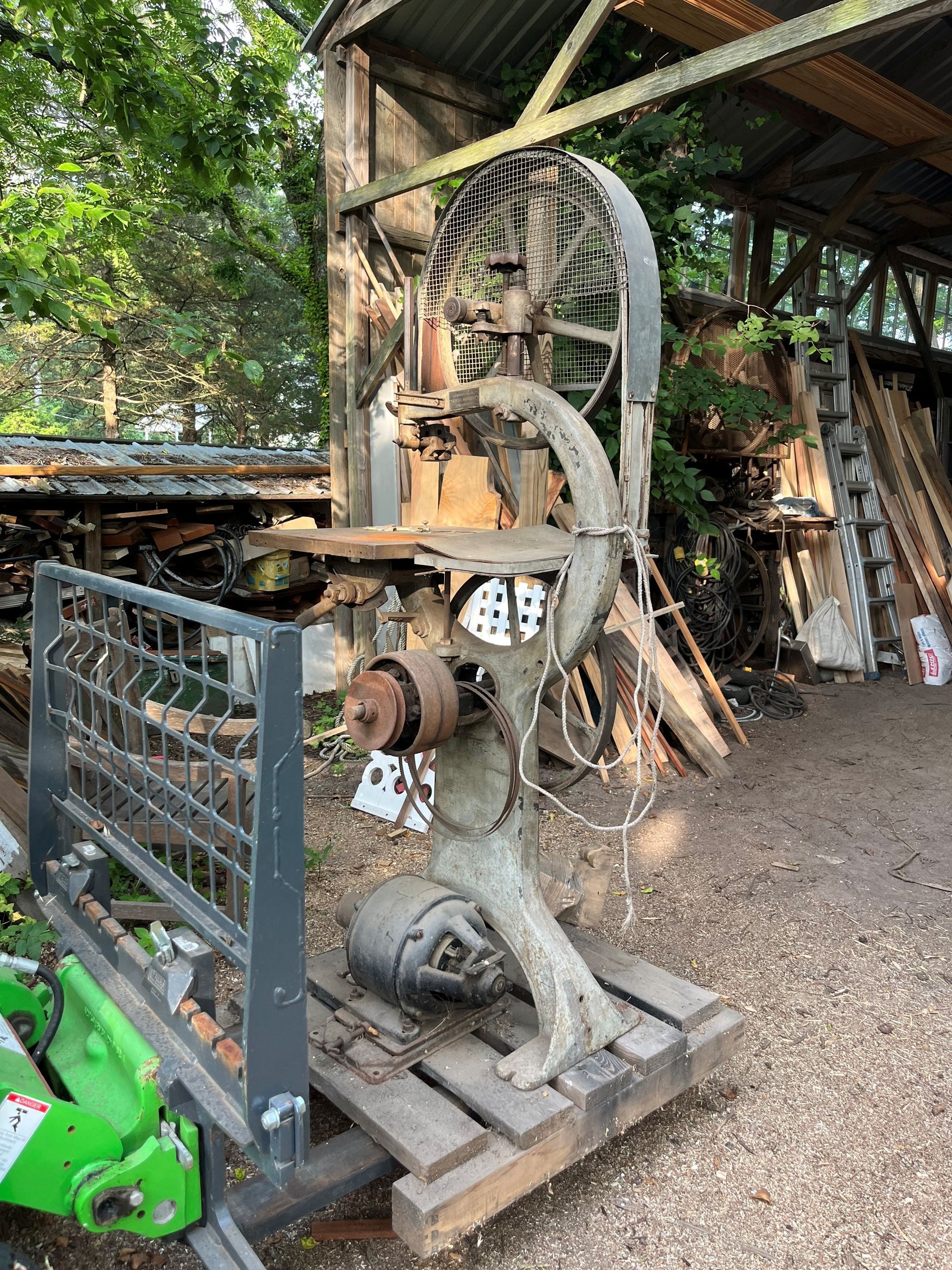 A large machine is sitting on a wooden pallet in a yard