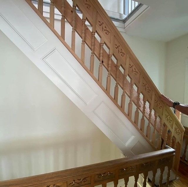 a wooden staircase with chinese writing on the railing
