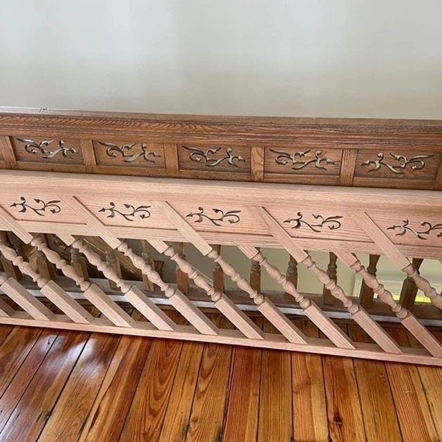 a wooden railing is sitting on a wooden floor .