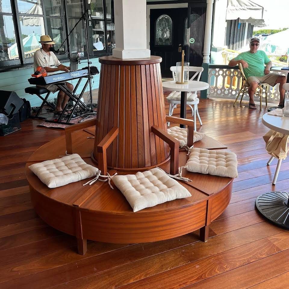 a man is playing an electric piano in a room with tables and chairs