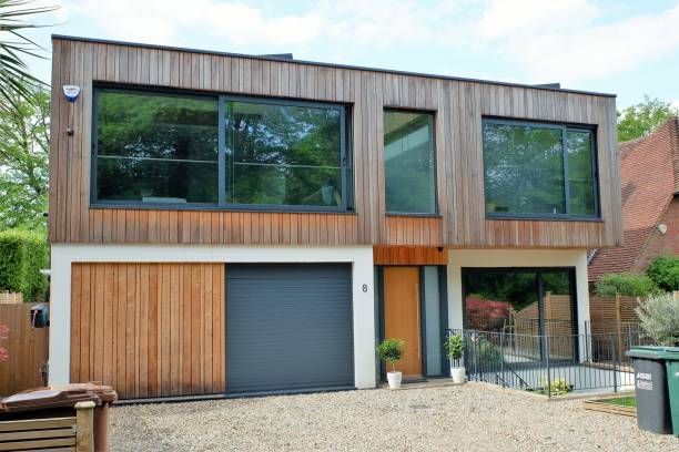 a modern house with a garage and a lot of windows .