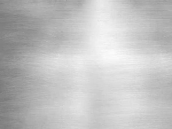 Superficie in metallo argentato spazzolato con morbidi riflessi di luce orizzontali.
