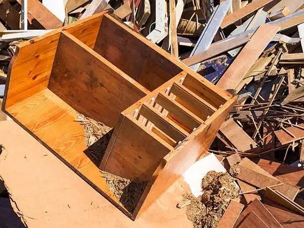 Mobili in legno rotti tra le macerie e i rottami di legno dopo un disastro o una demolizione.