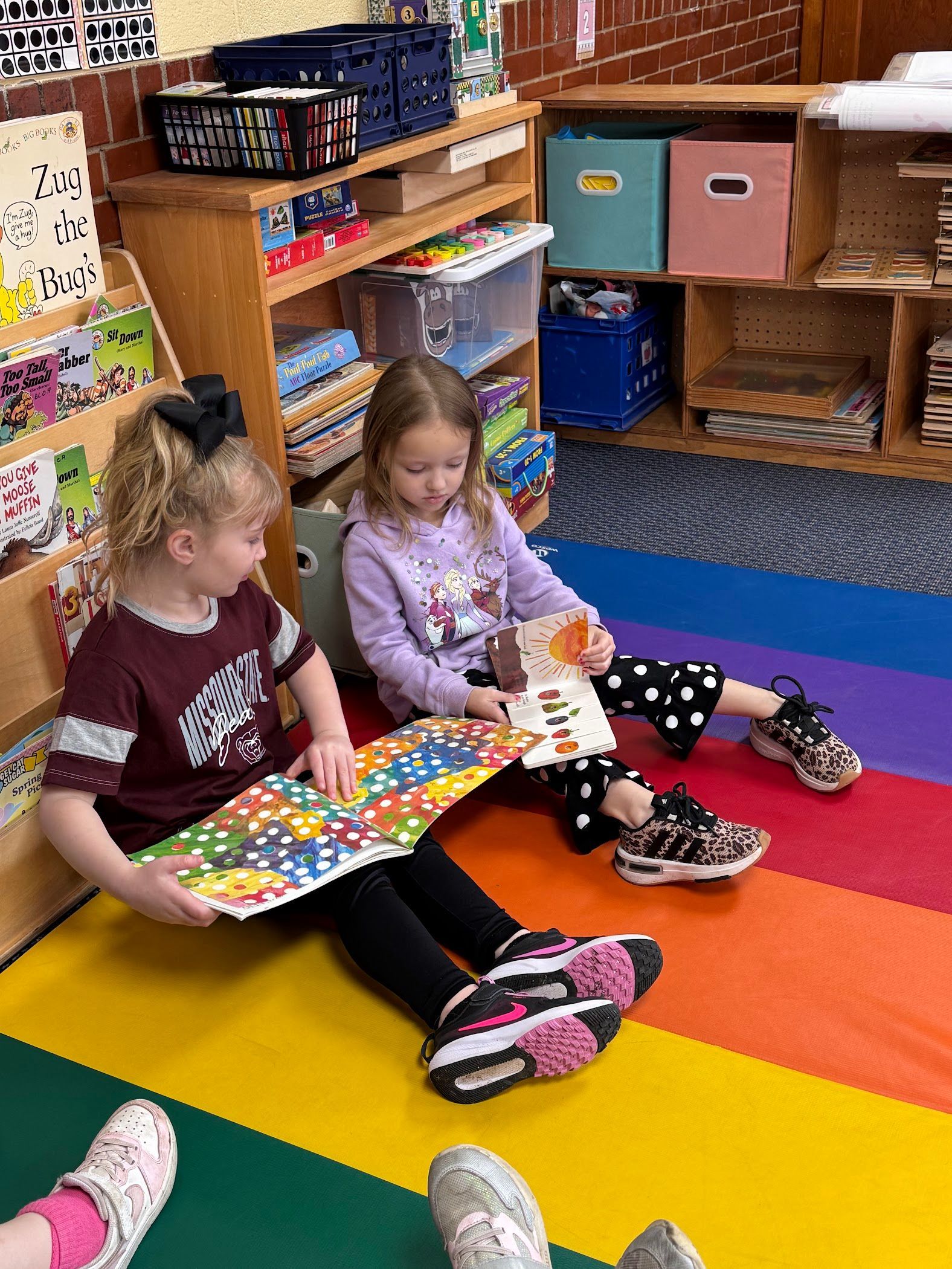 Middle school students teaching younger students in a classroom.