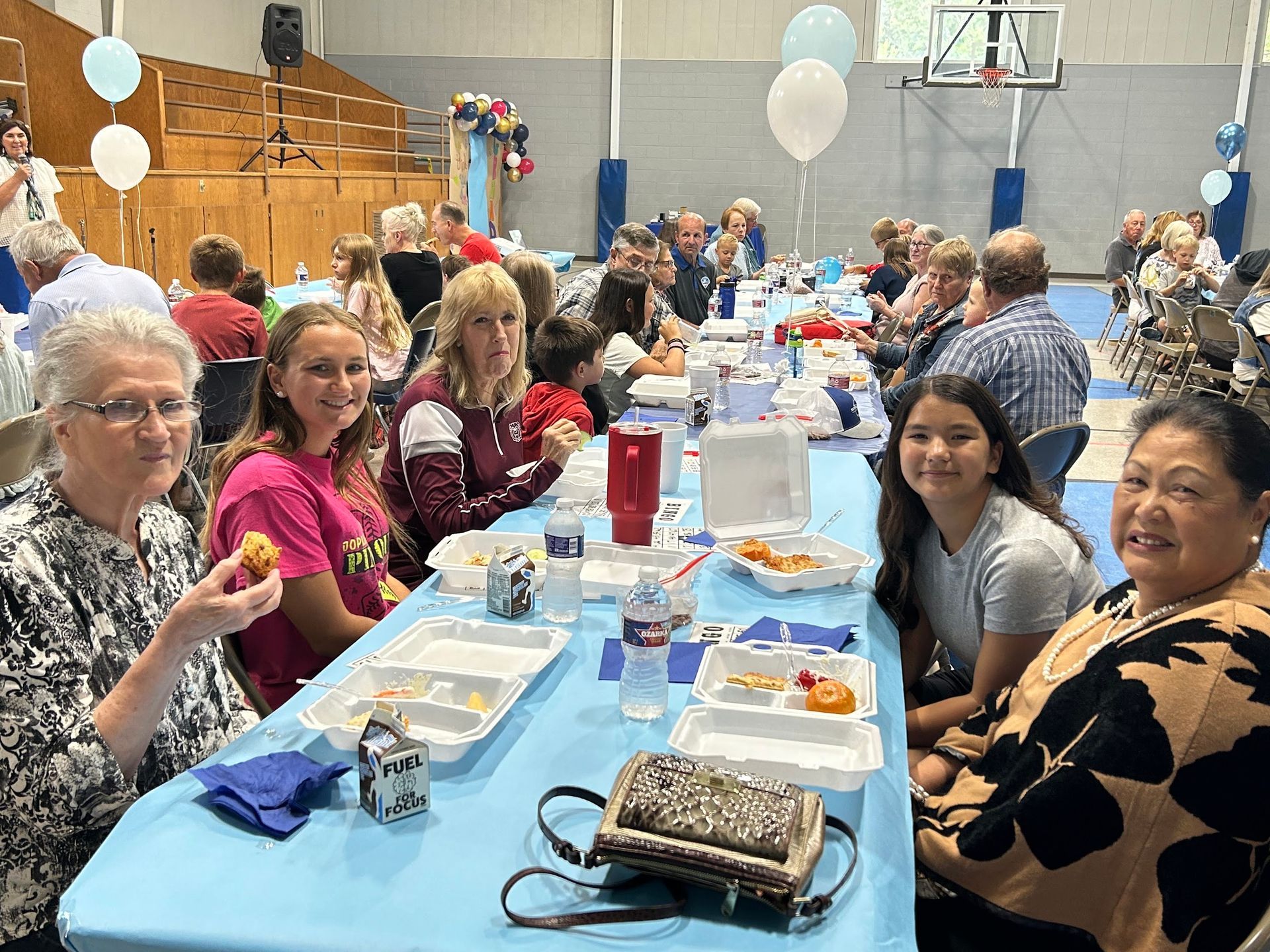Students and their grandparents playing BINGO during Grandparent's Day.