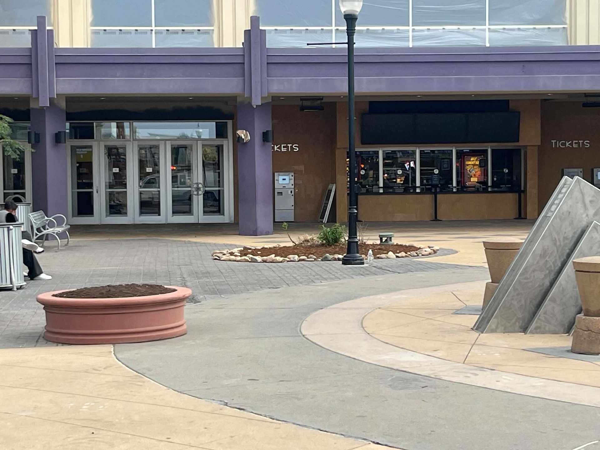 A purple building with a statue in front of it