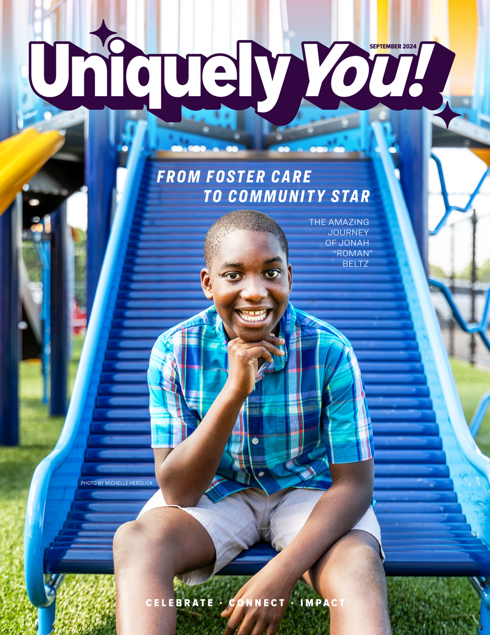 Smiling boy sits on blue playground slide under the words “Uniquely You!”