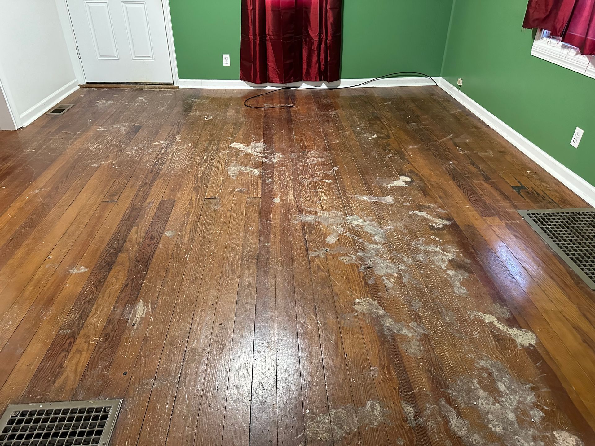 A room with a wooden floor and green walls