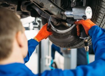 Technician performing repair on vehicle | Xpertech Auto Repair, Inc.