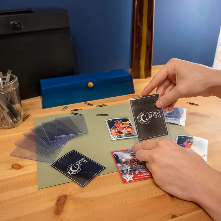 A person is holding a card that says eclipse on it