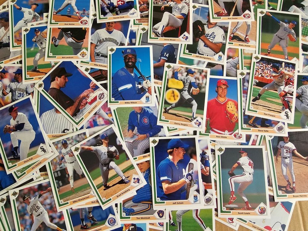 A bunch of baseball cards are stacked on top of each other