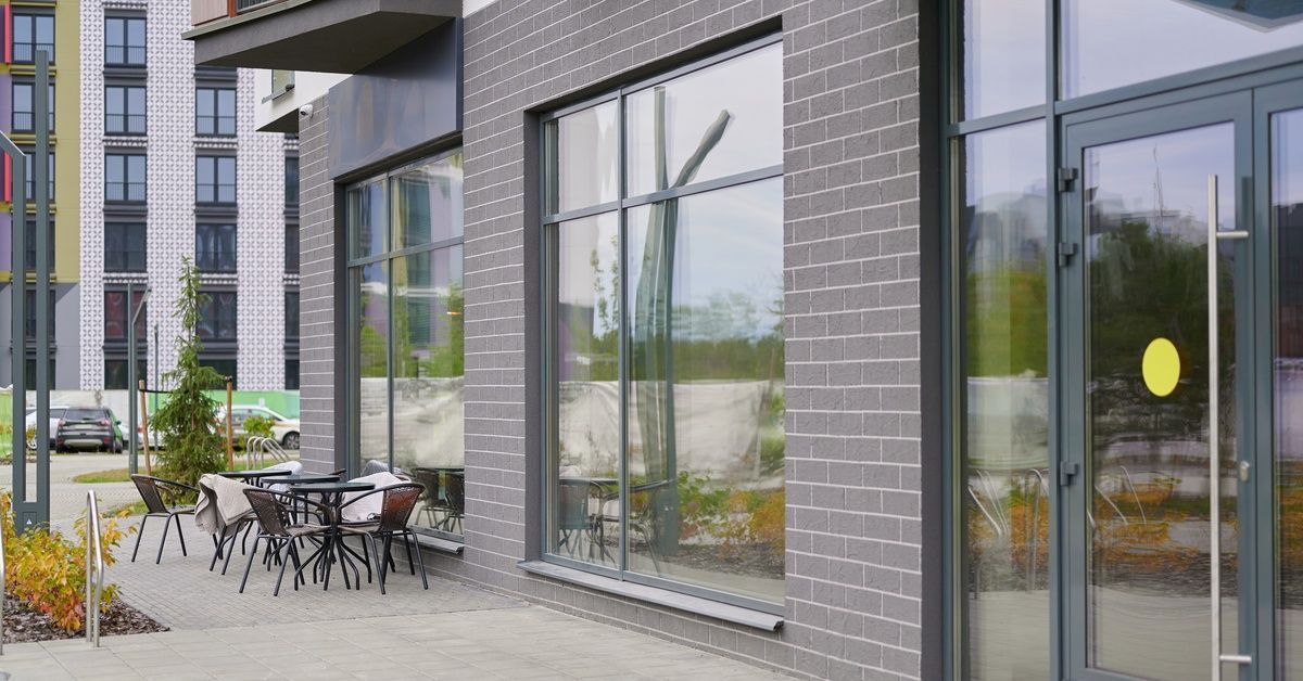 A modern downtown café features outdoor seating and large windows that wrap around the spacious building.