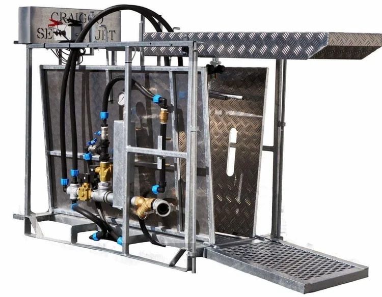 Industrial metal machine with black hoses, valves, and a diamond-plate ramp on a white background — Dusty Rural Contracting in Coolac, NSW