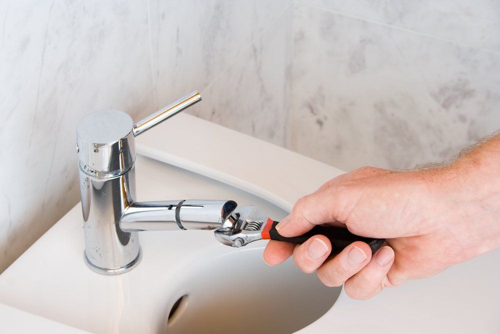Plumber Repairing The Filter Of A Faucet — Plumbers & Gasfitters In Highfields, QLD