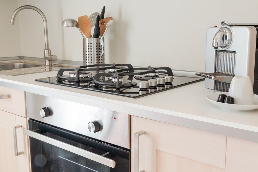 New Kitchen,  Counter Top With Assorted Utensils — Plumbers & Gasfitters In Highfields, QLD