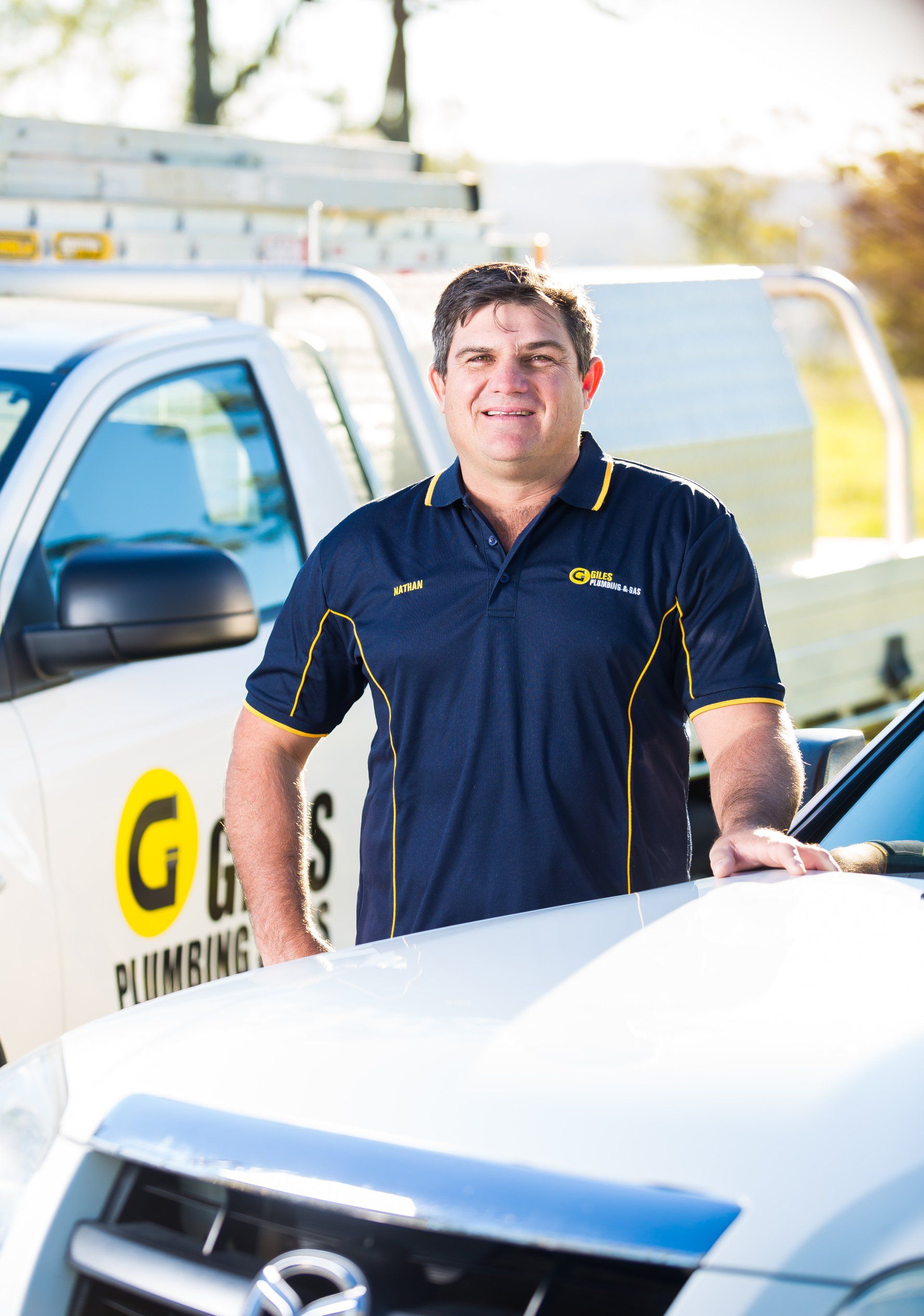 Team member standing by ute — Plumbers & Gasfitters In Toowoomba