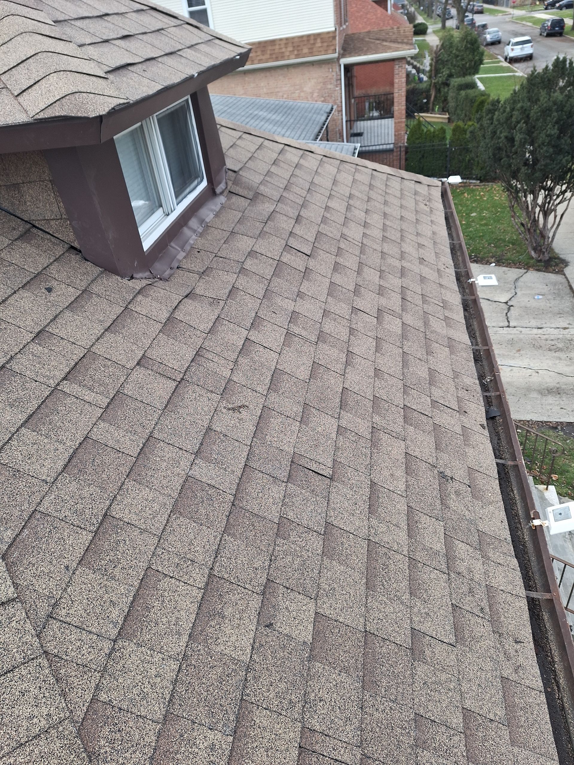 A close up of a roof with a window on top of it.
