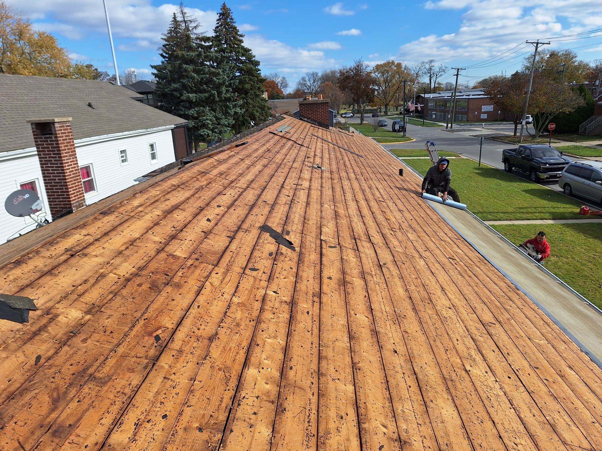 A man is working on the roof of a house.