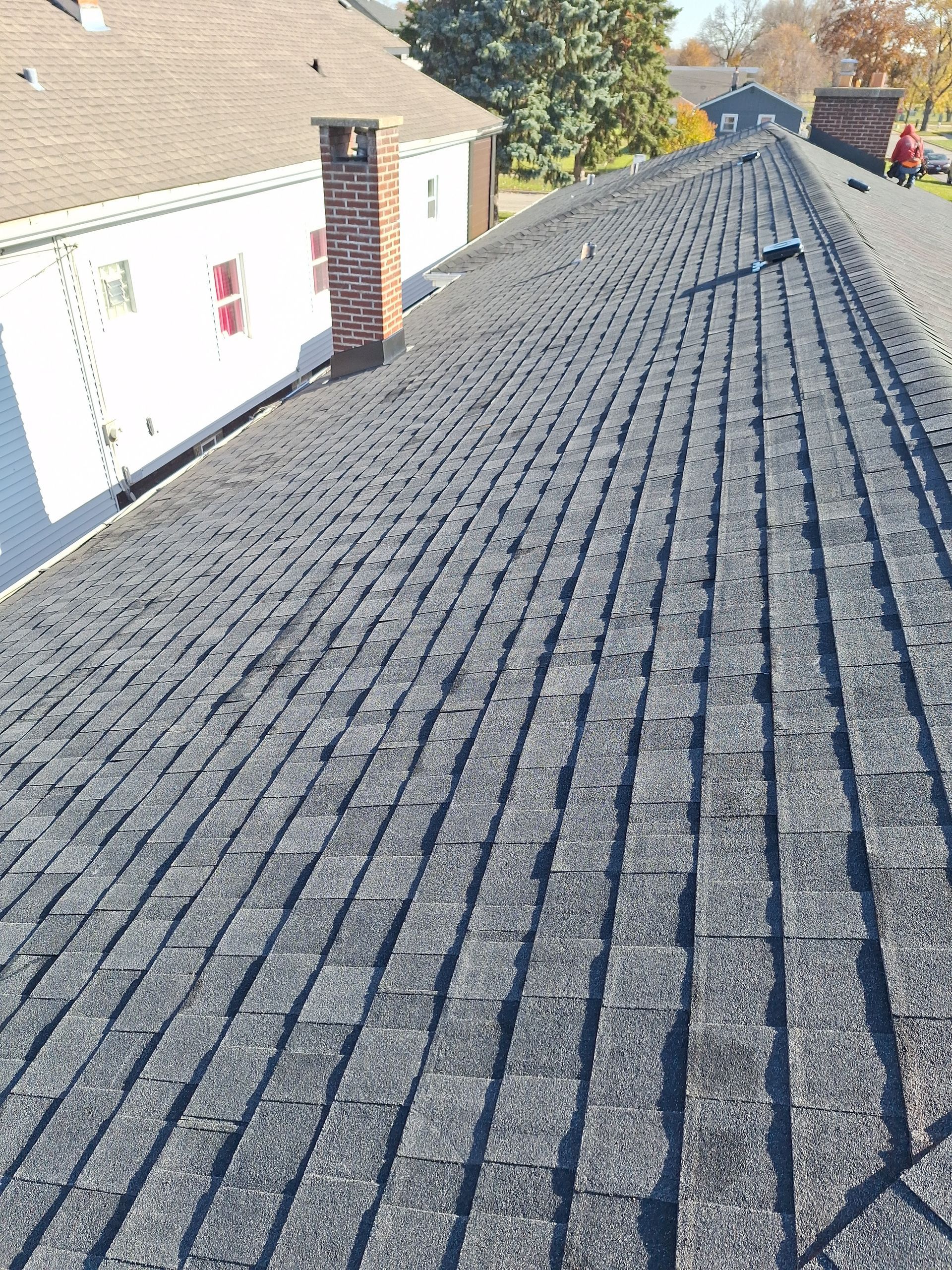 The roof of a house has a lot of shingles on it.