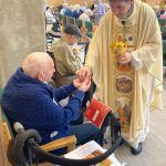 Archbishop Leo giving communion at mass