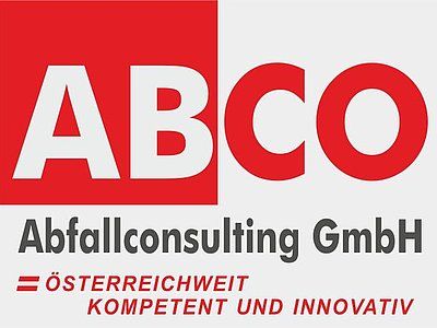 Silver Mercedes garbage truck, on a paved road, with green accents, clear sky.