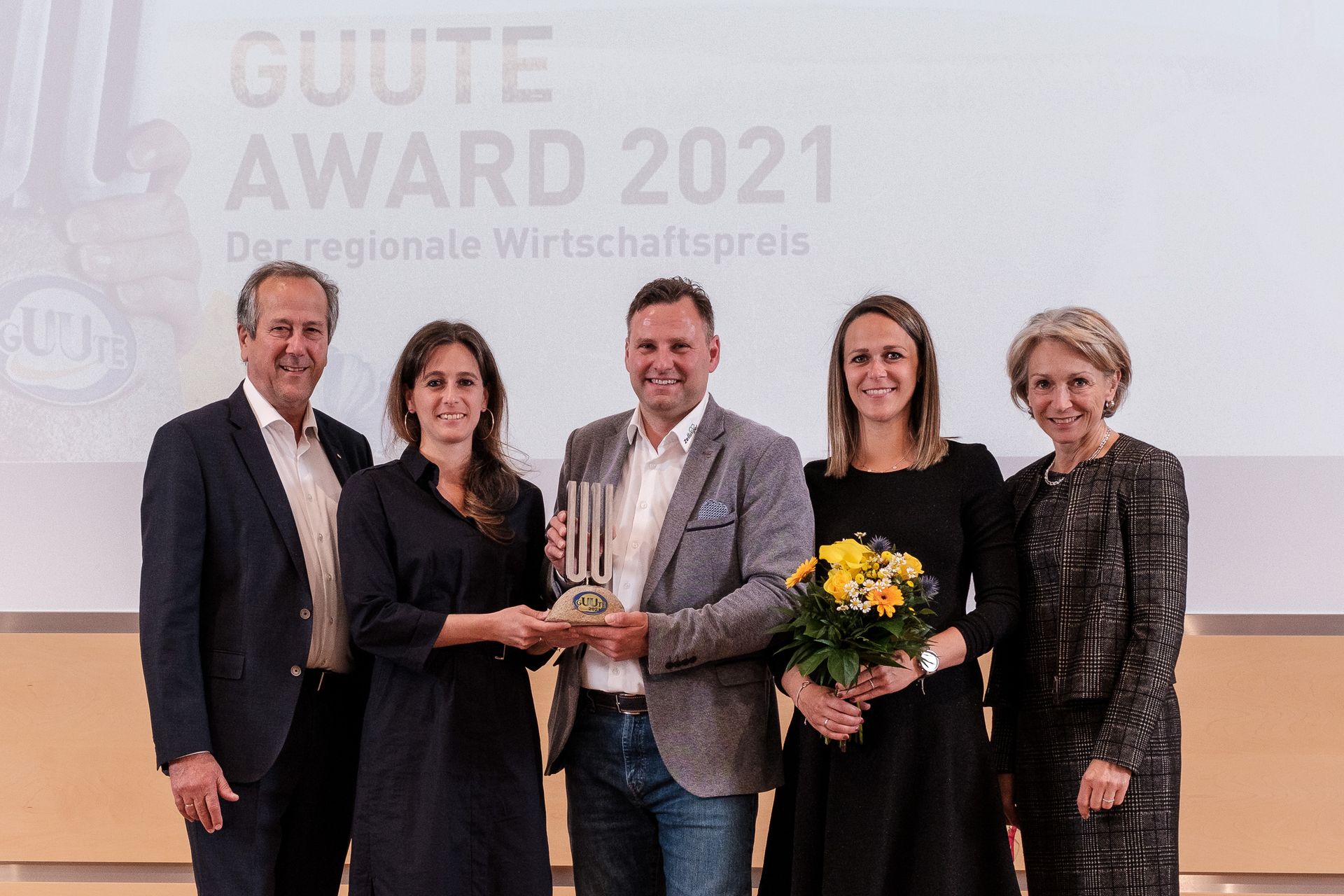 Group of people receiving an award on stage at 