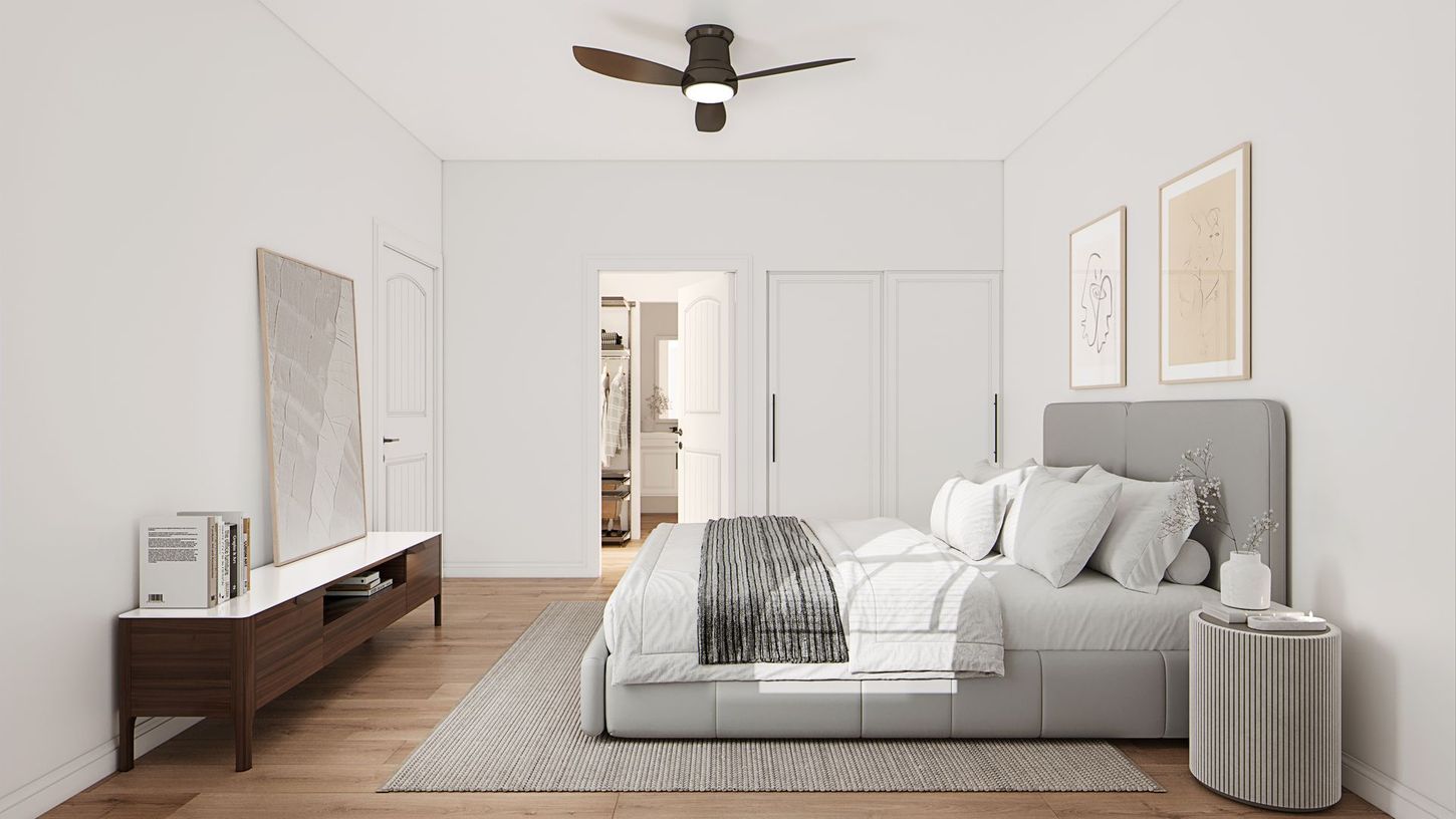 Bright minimalist bedroom with a gray bed, wood floor, white walls, and ceiling fan