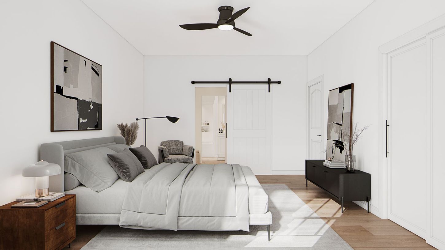 Bright minimalist bedroom with gray bed, white walls, wooden floor, and a black ceiling fan.