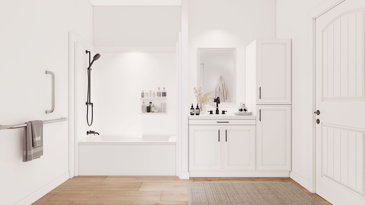 Bright white bathroom with a bathtub, shower, vanity, and double doors on a wood floor.