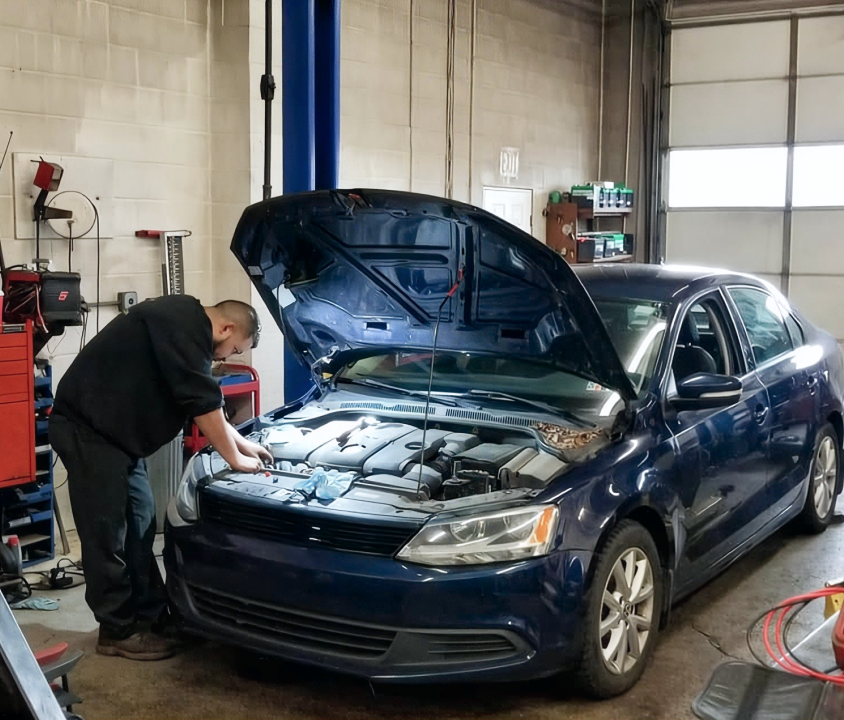 Mechanic working on a car | Longwood Tire & Service LLC