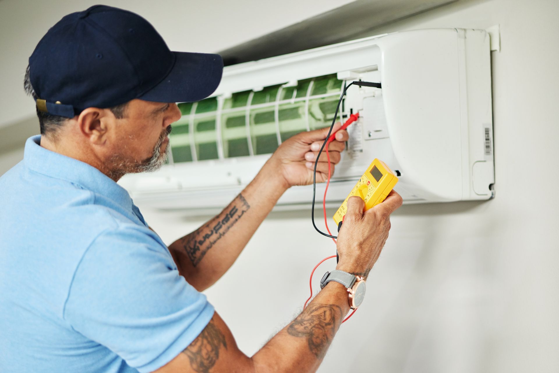 A man is working on an AC.
