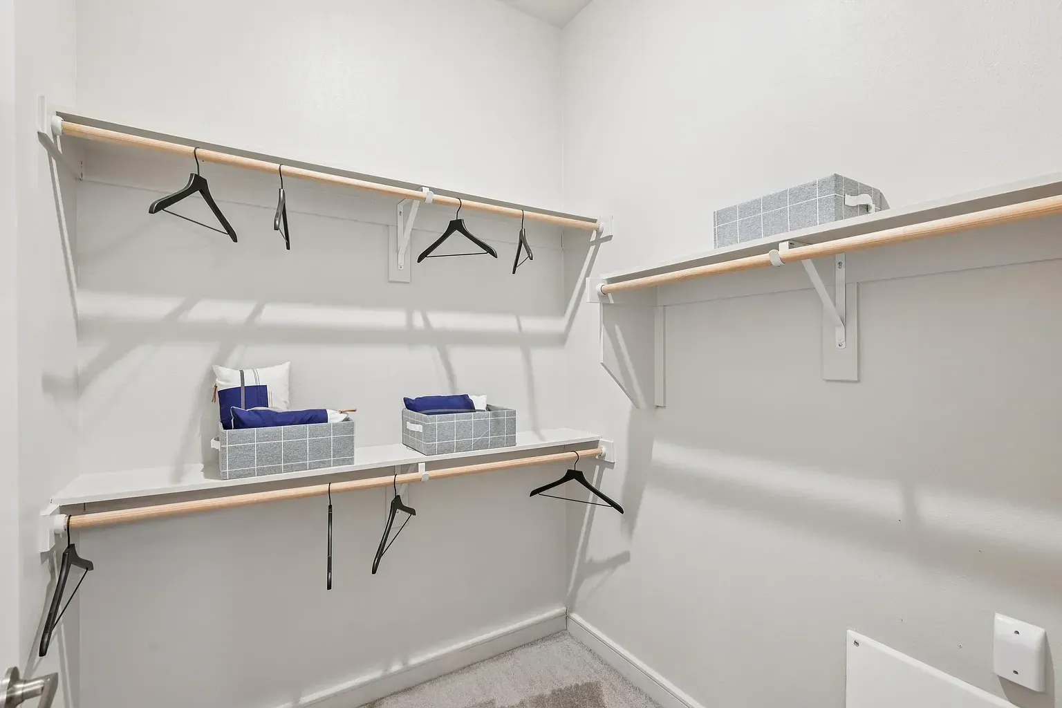 Walk-in closet with shelves and hanging rods.