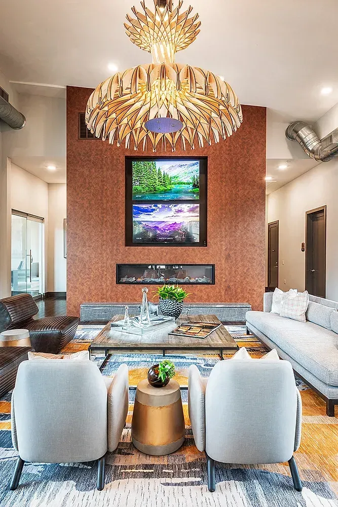 Modern living room with fireplace and large abstract art on the wall.