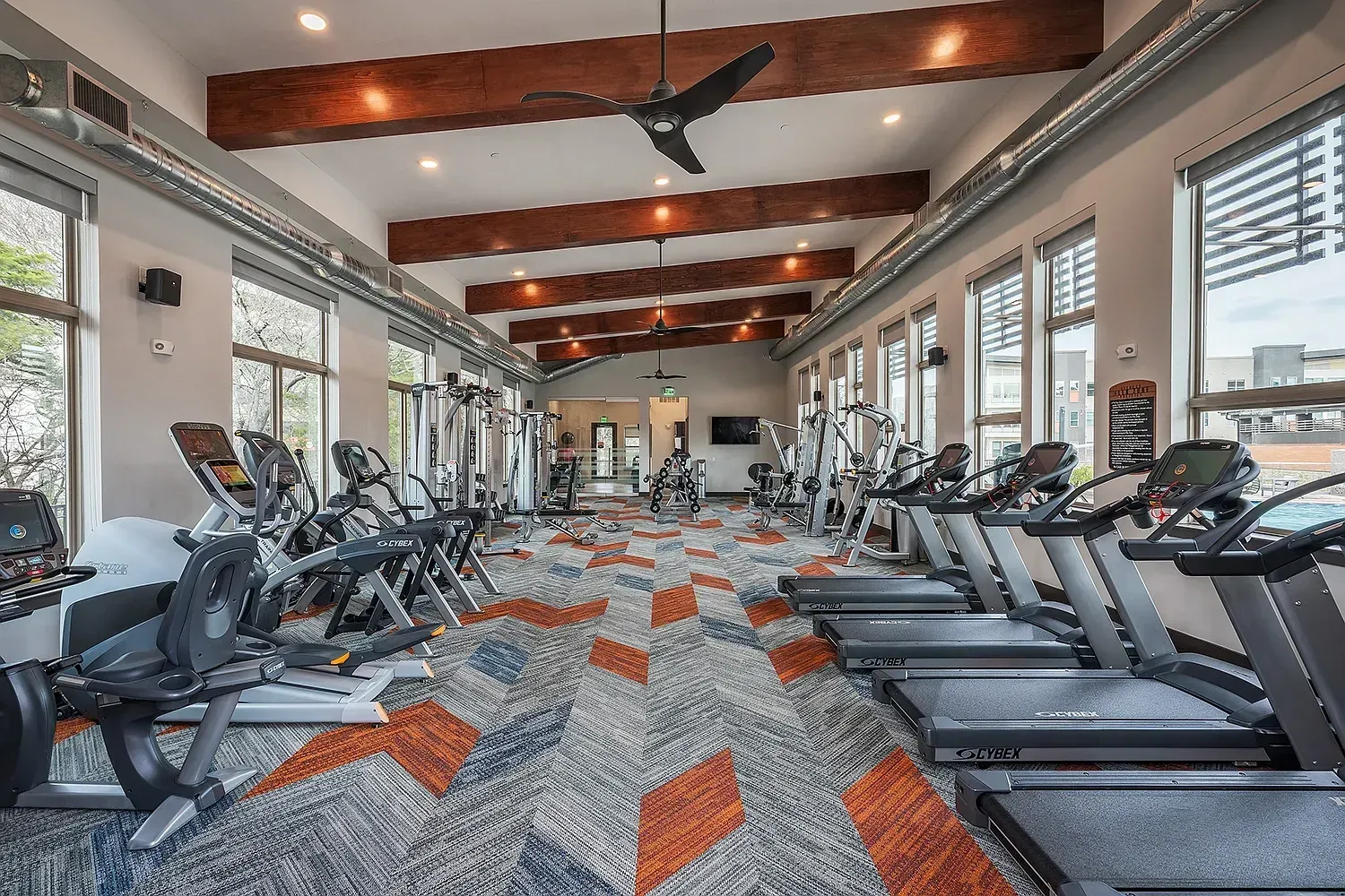 Spacious fitness center with treadmills, ellipticals, and weight machines.