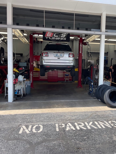 SUV On Lift Inside ECS Tuning Auto Repair Bay | Reeder's Auto & Tire Blog