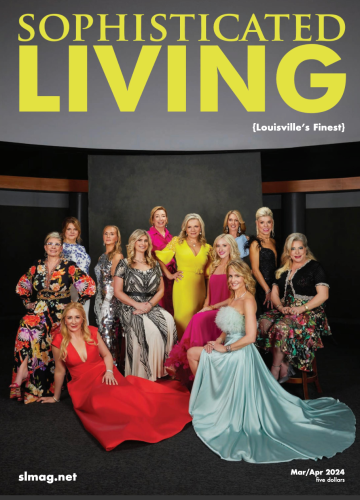 Group of twelve elegantly dressed people posing in front of a dark backdrop for the cover of Sophisticated Living magazine.