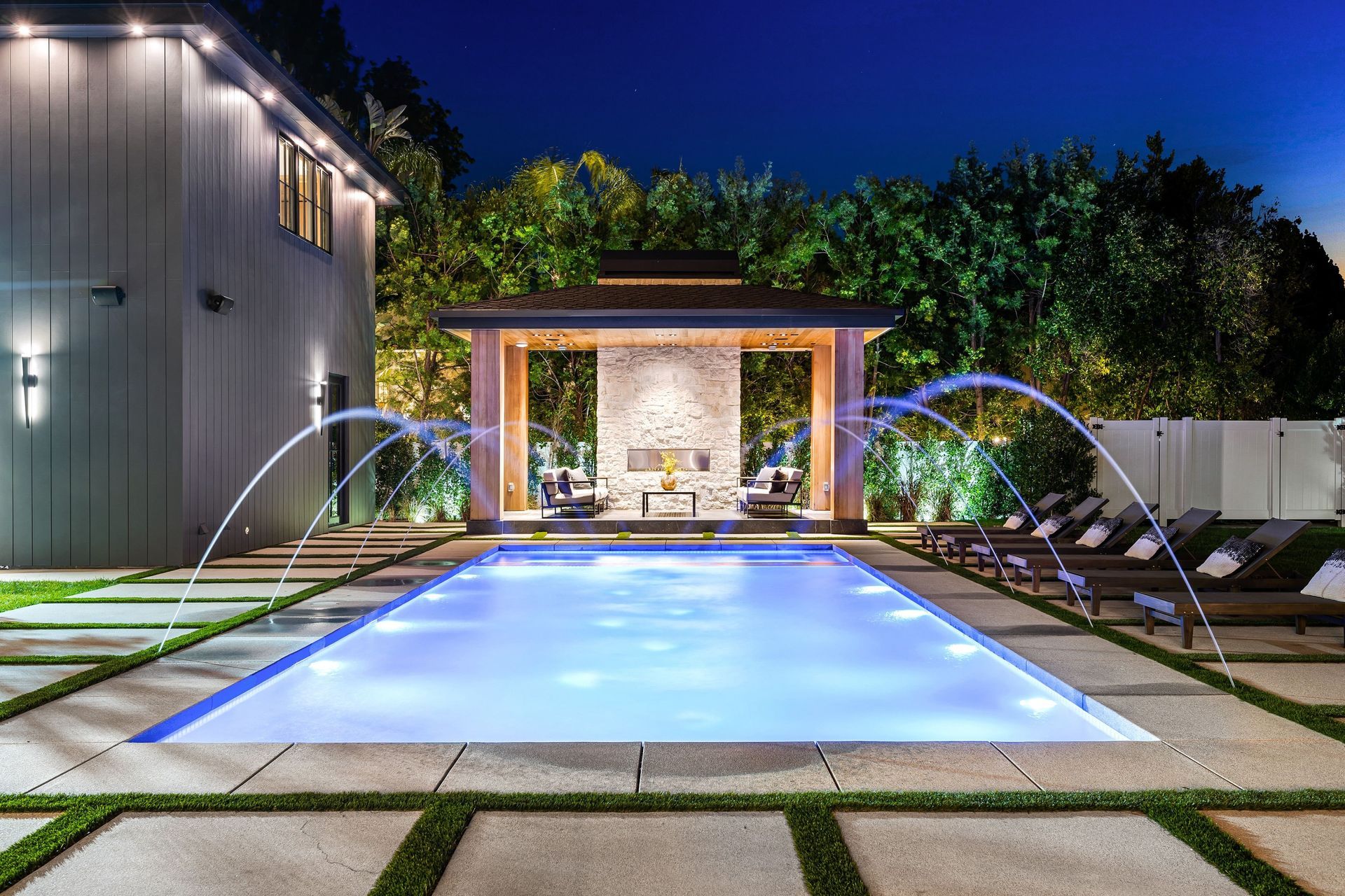 A large swimming pool with a gazebo in the background